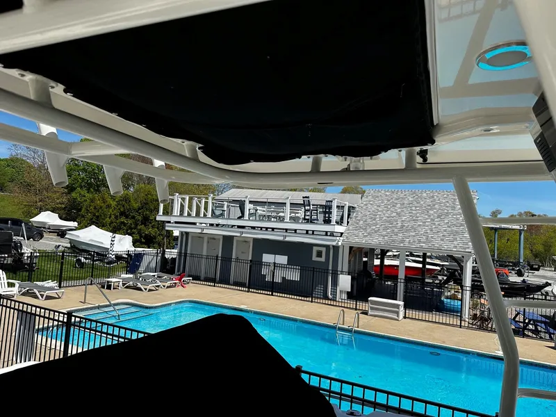 Slide: The Image of Boston Whaler 330 Outrage 2019 near a pool and boathouse. - 43