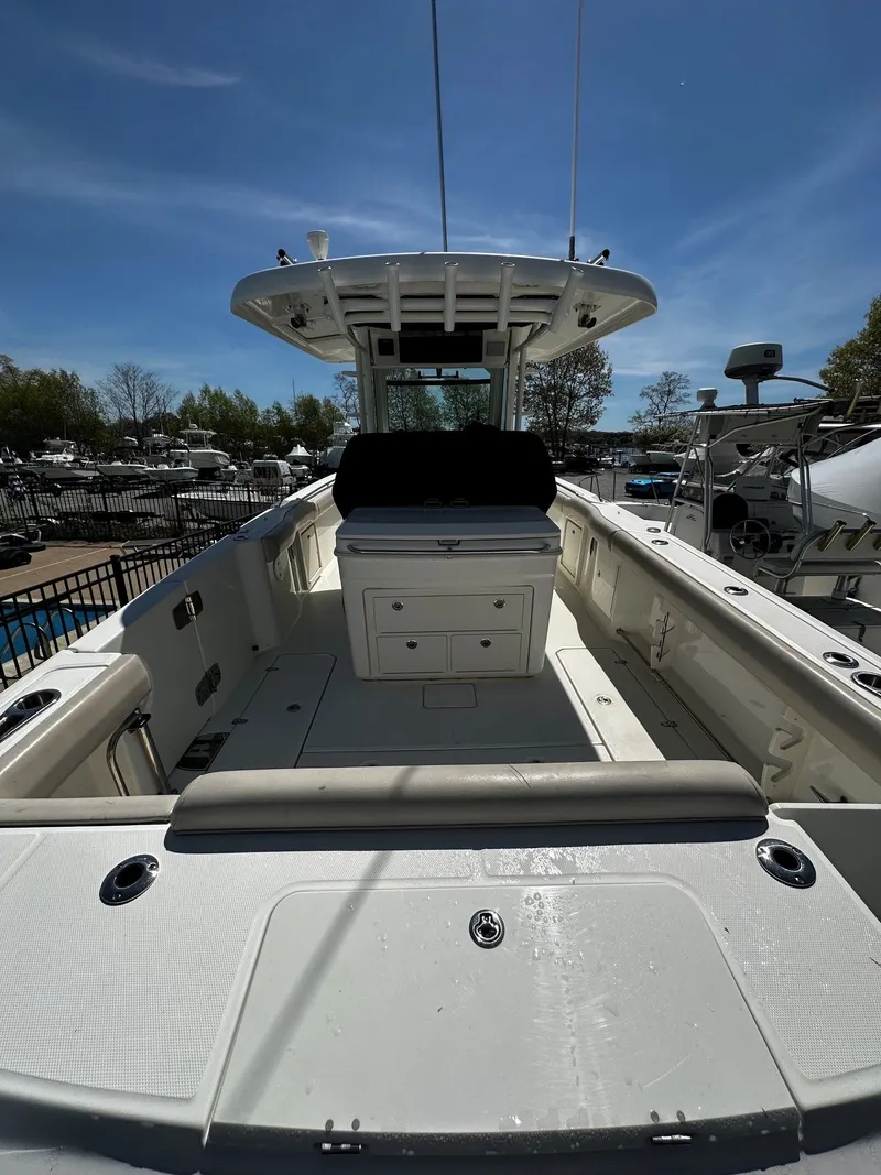 Slide: The Image of 2019 Boston Whaler 330 Outrage boat, spacious deck, sunny sky. - 7