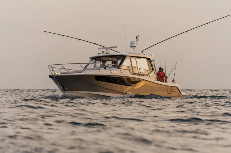 Slide: The Image of Boston Whaler 405 Conquest on calm water at sunset. - 33