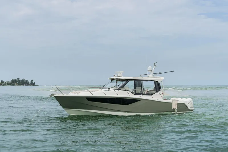 Slide: The Image of A 2026 Boston Whaler 405 Conquest cruising on calm waters. - 2