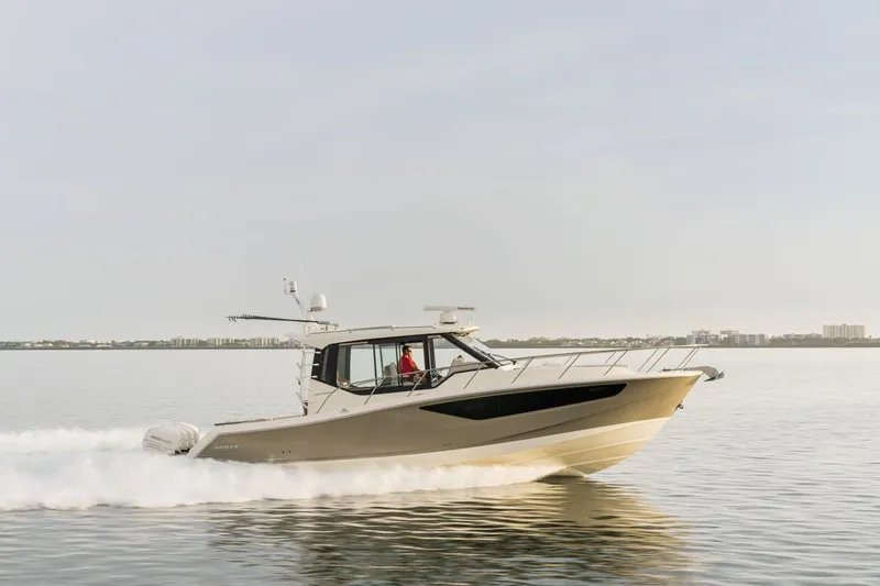 Slide: The Image of Boston Whaler 405 Conquest from 2026 cruising swiftly on calm water. - 5