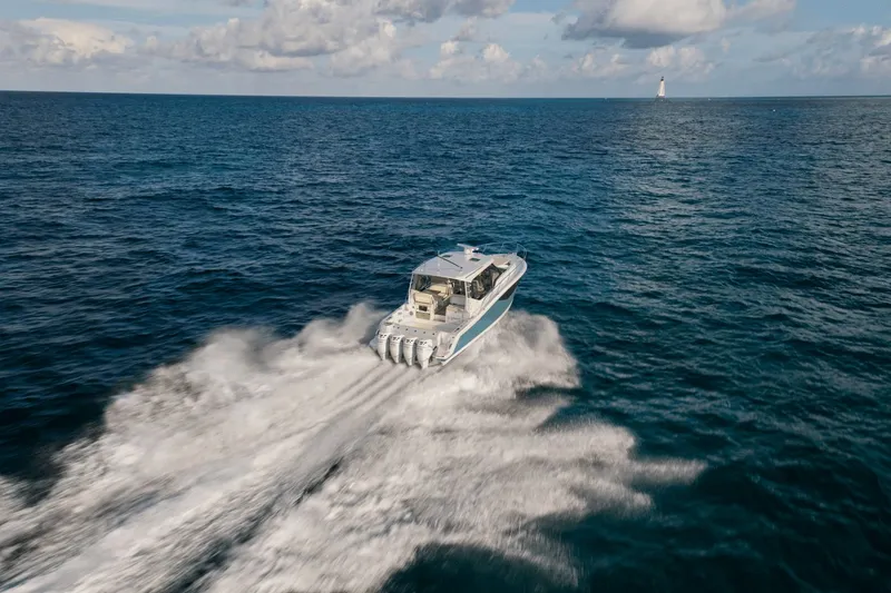Slide: The Image of A 2026 Boston Whaler 405 Conquest speeds across the open sea. - 15