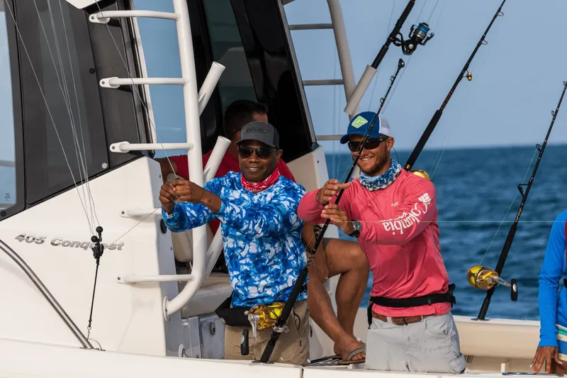 Slide: The Image of Two men fishing on a boat in the sea. - 22