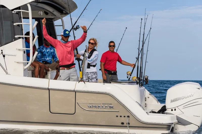 Slide: The Image of People fishing on a Boston Whaler 405 Conquest boat at sea. - 24