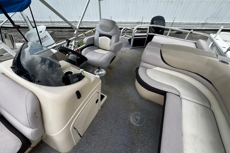 Slide: The Image of 2015 Sun Tracker Party Barge 22 DLX interior with helm, seating, and controls. - 6