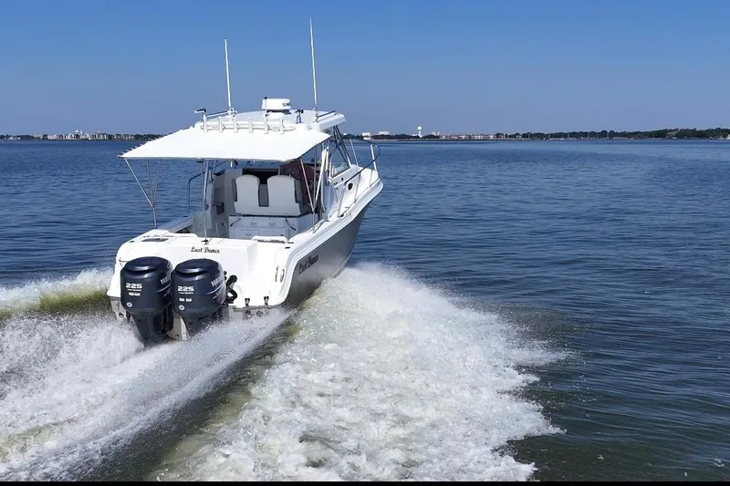 Slide: The Image of 2007 Polar 2700 Walkaround boat cruising on open water with twin Yamaha engines. - 11