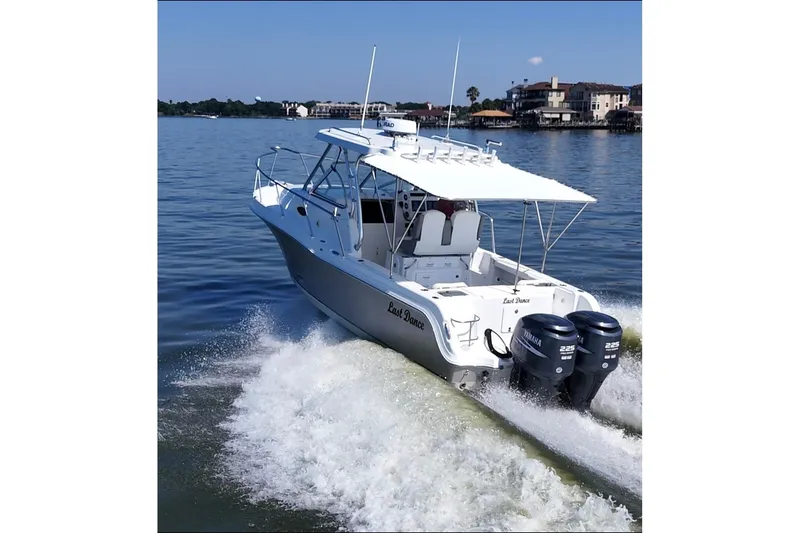 Slide: The Image of 2007 Polar 2700 Walkaround boat cruising on a calm lake with twin Yamaha engines. - 12