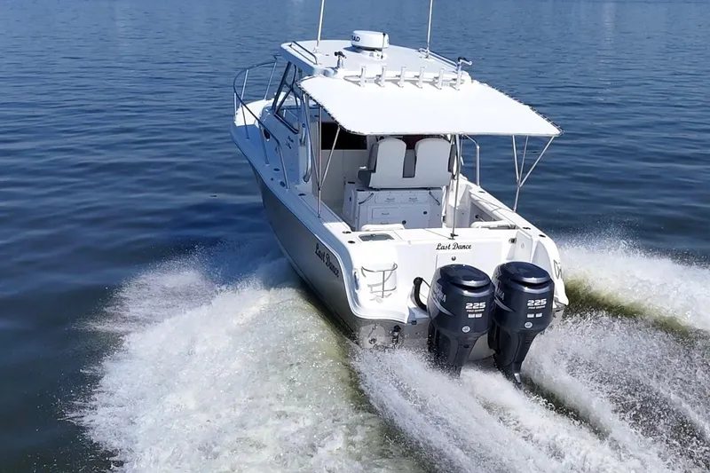 Slide: The Image of 2007 Polar 2700 Walkaround boat cruising on water with twin Yamaha engines. - 13