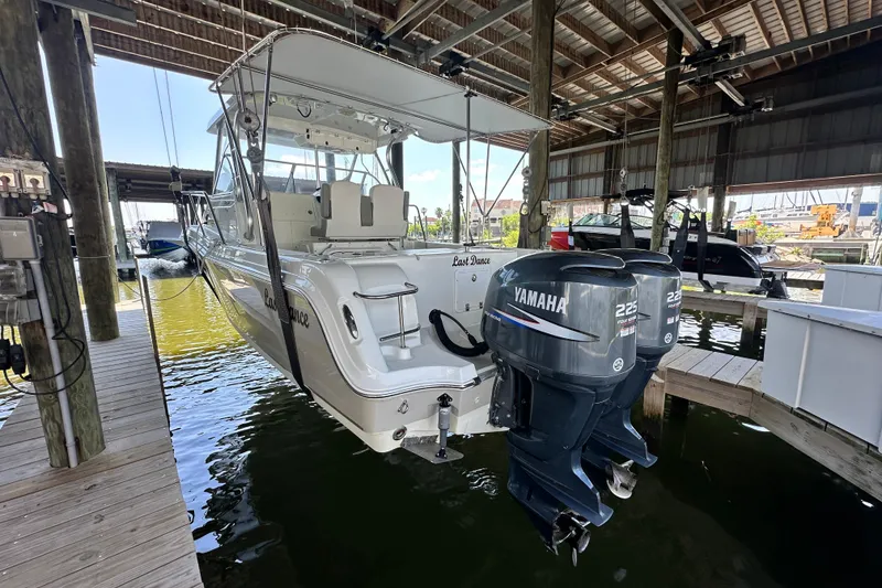 Slide: The Image of 2007 Polar 2700 Walkaround boat with twin Yamaha 225 engines in a covered dock. - 15