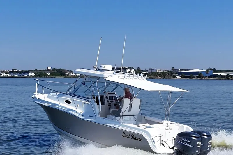 Slide: The Image of 2007 Polar 2700 Walkaround boat cruising on water with twin Yamaha engines. - 2