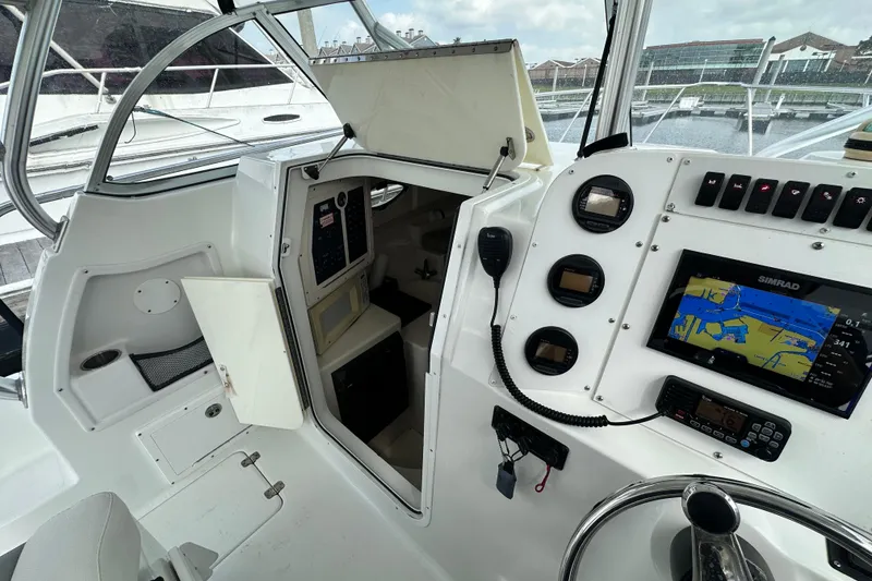 Slide: The Image of 2007 Polar 2700 Walkaround boat cockpit with navigation equipment and open cabin door. - 20