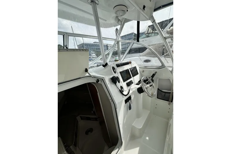 Slide: The Image of 2007 Polar 2700 Walkaround boat interior with steering wheel and control panel. - 23