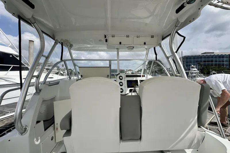 Slide: The Image of 2007 Polar 2700 Walkaround boat interior with helm, seats, and marina view. - 29