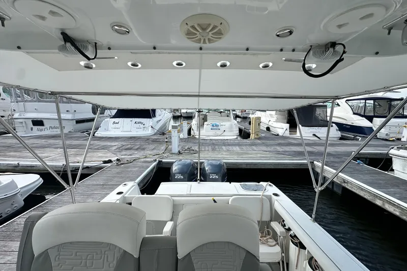 Slide: The Image of 2007 Polar 2700 Walkaround boat docked at marina, featuring dual engines and spacious seating. - 30