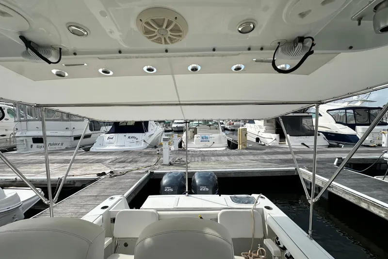 Slide: The Image of 2007 Polar 2700 Walkaround boat docked at marina with twin engines. - 34
