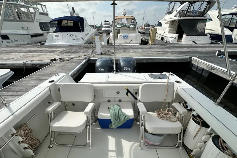 Slide: The Image of 2007 Polar 2700 Walkaround boat docked at marina with twin engines. - 38