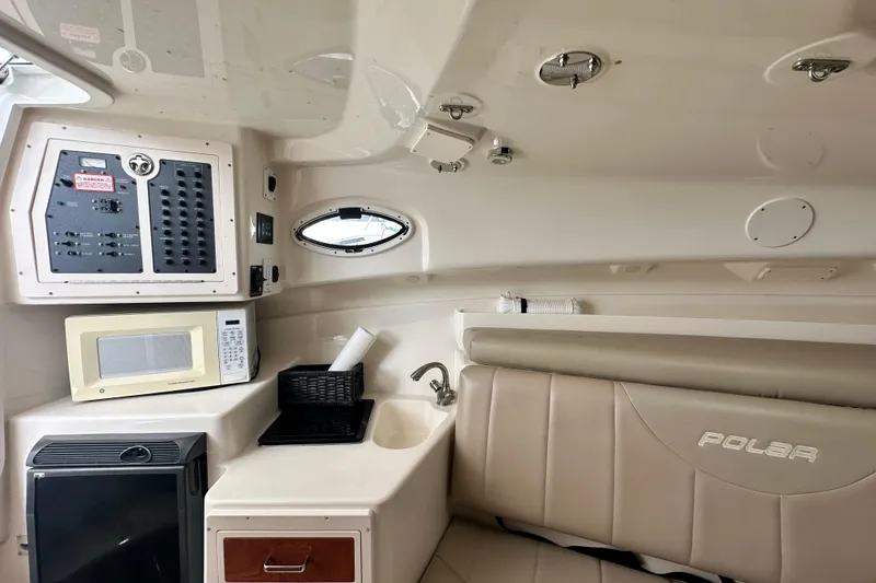 Slide: The Image of 2007 Polar 2700 Walkaround cabin interior with microwave, sink, and control panel. - 45