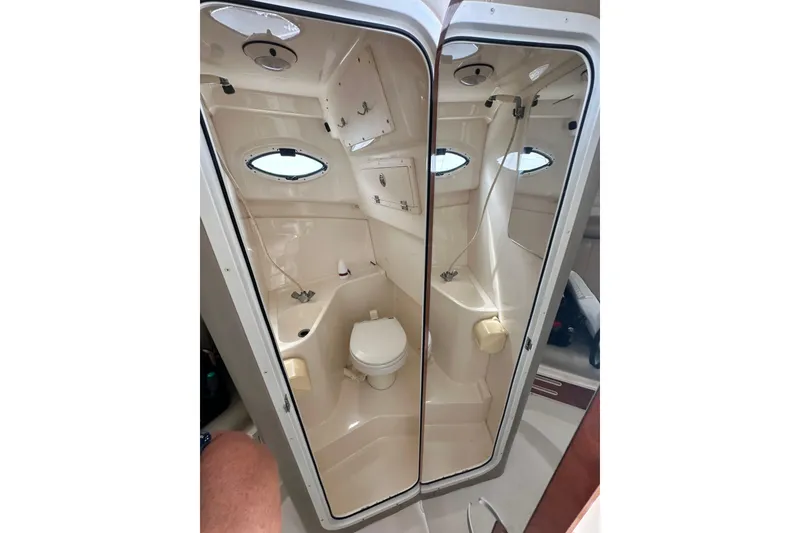 Slide: The Image of 2007 Polar 2700 Walkaround boat interior with compact bathroom and porthole window. - 47