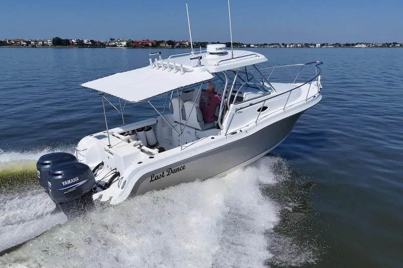 Slide: The Image of 2007 Polar 2700 Walkaround boat cruising on water with twin Yamaha engines. - 6