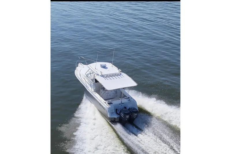 Slide: The Image of 2007 Polar 2700 Walkaround boat cruising on open water, rear view. - 8