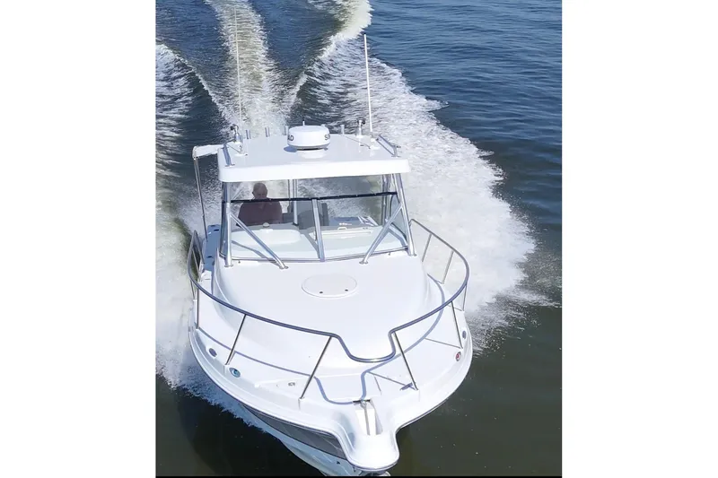 Slide: The Image of 2007 Polar 2700 Walkaround boat cruising on open water, aerial view. - 9
