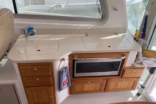 Slide: The Image of Interior view of a 2013 Back Cove 34 yacht kitchen with countertop and microwave. - 11