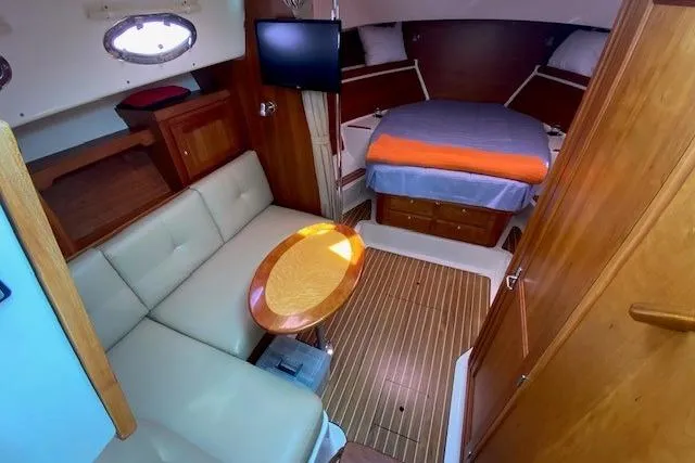 Slide: The Image of Interior of 2013 Back Cove 34 boat with cozy seating and bed area. - 13