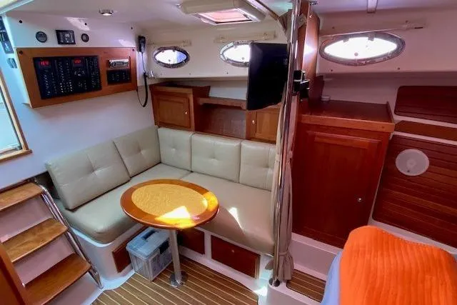 Slide: The Image of Cozy interior of 2013 Back Cove 34 yacht with seating, table, and wood accents. - 14