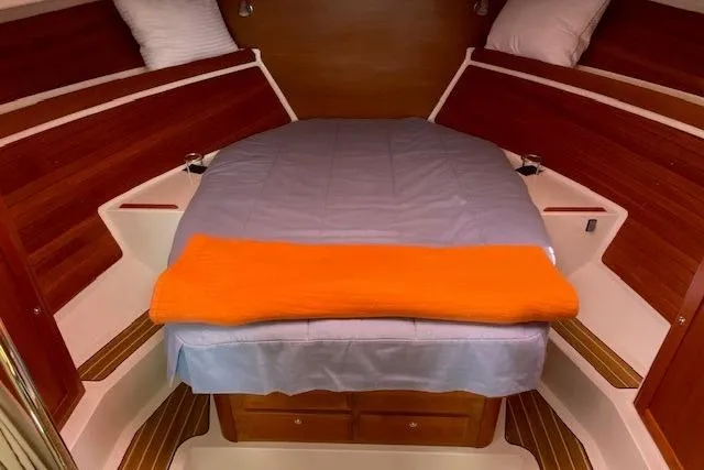 Slide: The Image of Cozy cabin interior of 2013 Back Cove 34 boat with bed and wooden accents. - 15