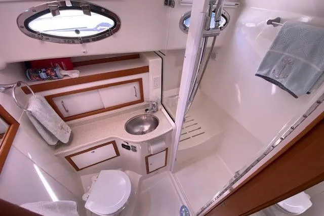 Slide: The Image of 2013 Back Cove 34 yacht bathroom with sink, toilet, and shower. - 17
