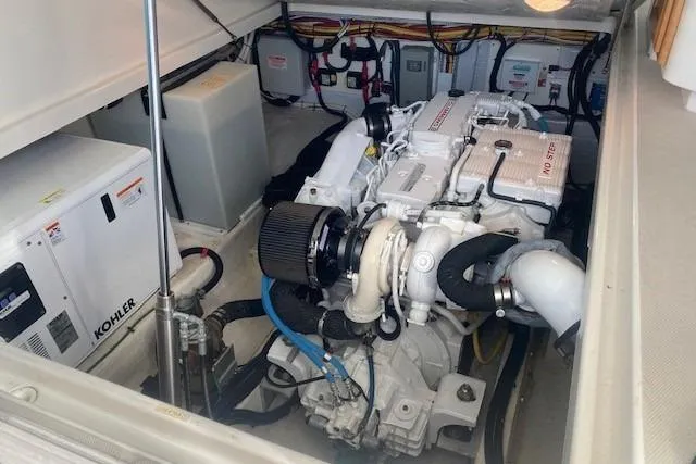 Slide: The Image of Engine room of a 2013 Back Cove 34 boat, featuring a Kohler generator. - 18