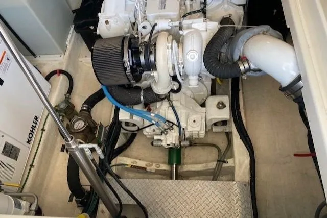 Slide: The Image of Engine compartment of a 2013 Back Cove 34 boat, featuring a Kohler generator. - 19