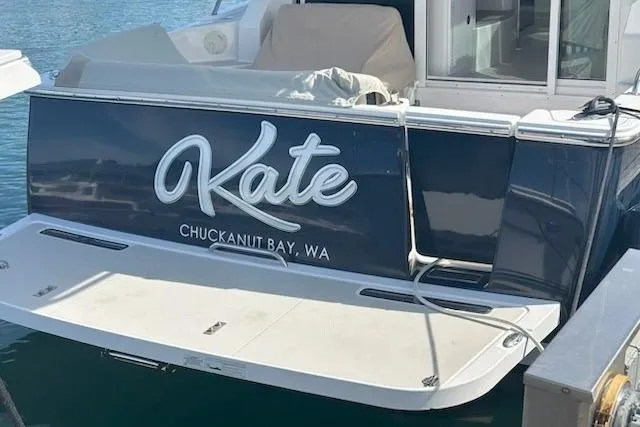 Slide: The Image of 2013 Back Cove 34 boat with striped seating in docked position. - 2