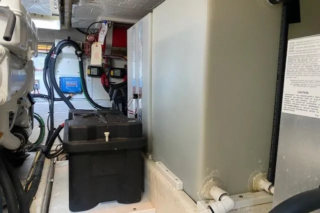 Slide: The Image of Engine room of a 2013 Back Cove 34 boat, featuring battery and wiring components. - 21