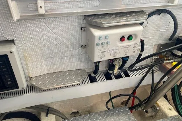 Slide: The Image of Engine compartment of a 2013 Back Cove 34 boat, featuring control panel and wiring. - 22