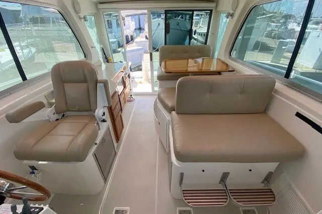 Slide: The Image of Interior of a 2013 Back Cove 34 boat with seating and helm station. - 8