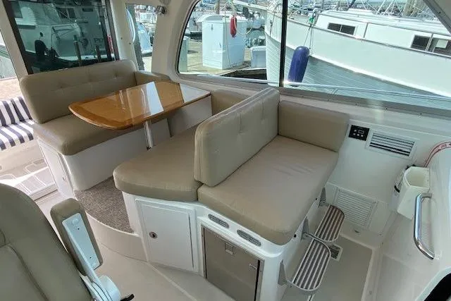 Slide: The Image of Interior of 2013 Back Cove 34 yacht with beige seating and wooden table. - 9
