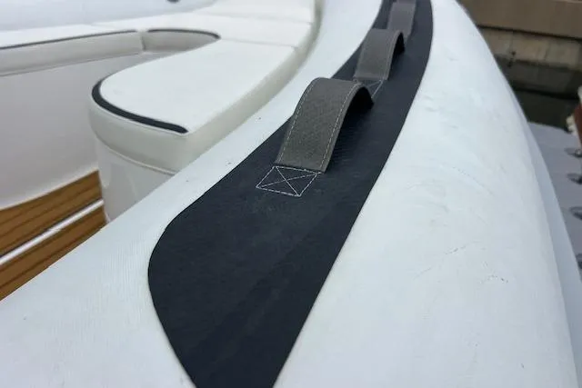 Slide: The Image of 2023 Novurania Como 18 boat detail, featuring white seating and black handle. - 10