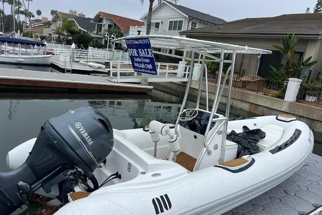 Slide: The Image of 2023 Novurania Como 18 boat with Yamaha motor docked, for sale sign visible. - 17