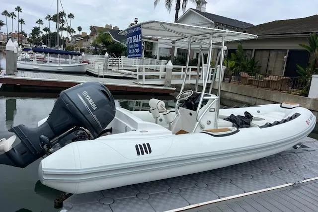 Slide: The Image of 2023 Novurania Como 18 boat docked with Yamaha engine, marina background. - 22
