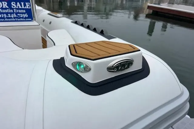 Slide: The Image of 2023 Novurania Como 18 boat detail with green navigation light and wooden deck accent. - 7