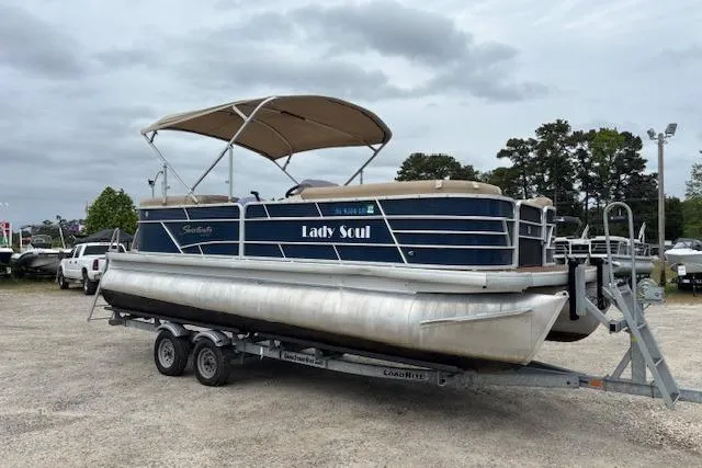 The Image of 2019 Sweetwater 2286 pontoon boat on trailer, named "Lady Soul," parked outdoors. - 1
