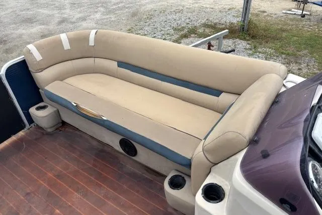 Slide: The Image of 2019 Sweetwater 2286 boat interior with beige seating and cup holders. - 10