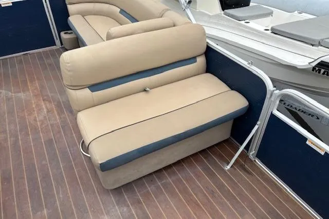 Slide: The Image of 2019 Sweetwater 2286 boat interior with beige seating and wooden flooring. - 12