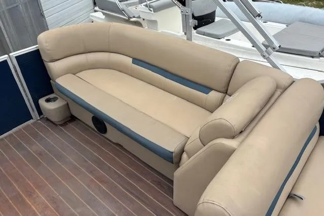 Slide: The Image of 2019 Sweetwater 2286 boat with beige seating and wooden deck. - 13