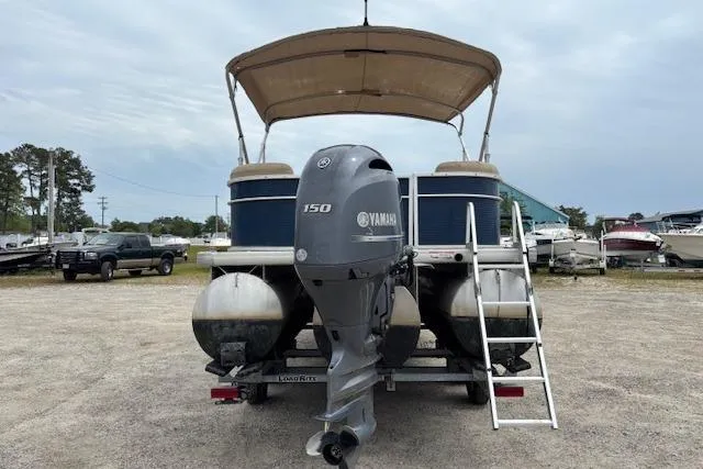 Slide: The Image of 2019 Sweetwater 2286 pontoon boat with Yamaha 150 engine, parked on gravel lot. - 4