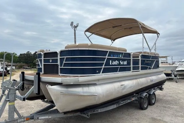 Slide: The Image of 2019 Sweetwater 2286 pontoon boat on trailer, featuring blue exterior and canopy. - 7