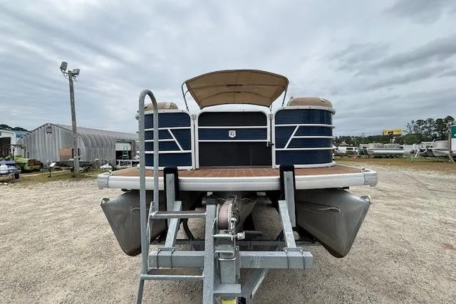 Slide: The Image of 2019 Sweetwater 2286 pontoon boat on trailer, parked outdoors under cloudy sky. - 8