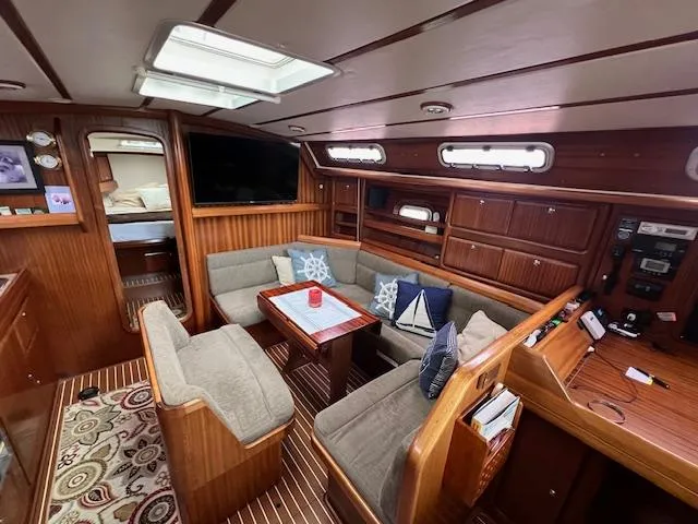 Slide: The Image of Interior of 2000 Bavaria 42 Cruiser yacht with cozy seating and wooden finishes. - 26