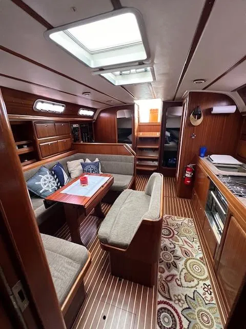 Slide: The Image of Interior of 2000 Bavaria 42 Cruiser yacht with cozy seating and wooden finishes. - 27